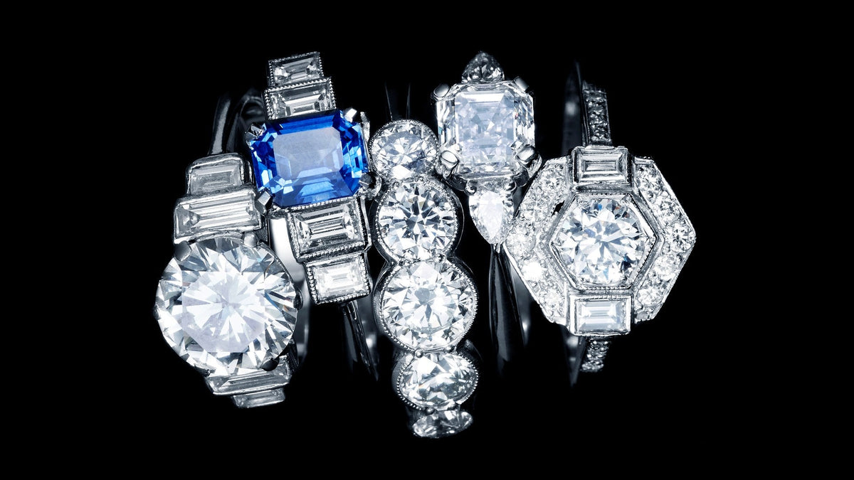 Art Deco style Diamond rings with Baguette Diamonds and geometric settings, one set with a Sapphire